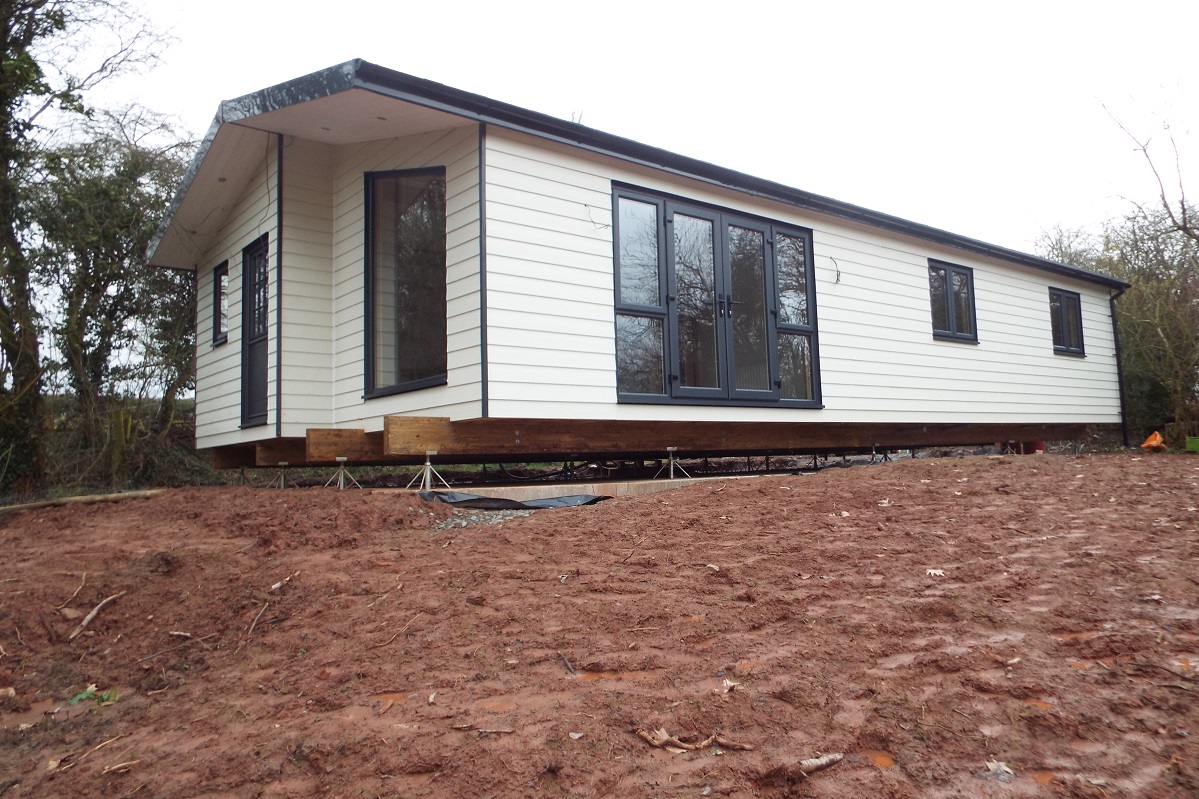 Log cabin mobile home delivered and pieced together