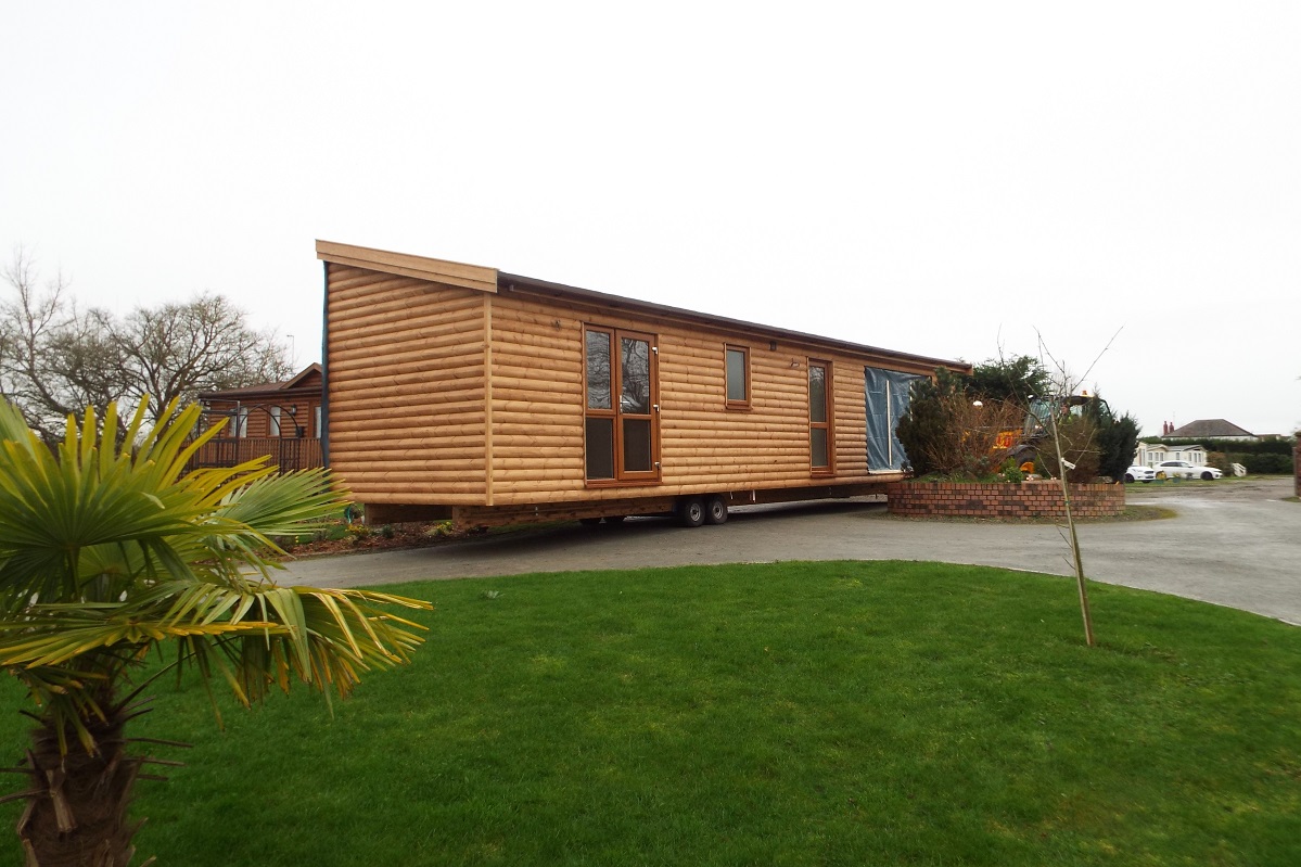 Log cabin mobile home delivered and sited this week